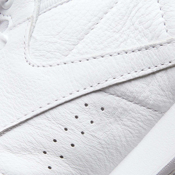 Close-up of the Reebok Women's Freestyle Hi Shoes in white leather, featuring textured material, detailed stitching, and three small ventilation holes—ideal for women's fitness or high top sneaker fans.