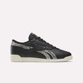 Almostblack Reebok Women’s Freestyle Lo Shoes featuring Vintagechalk soles and Reeboklightgold snakeskin-patterned accents on the side stripes and heel, displayed in a left side view against a plain white background.