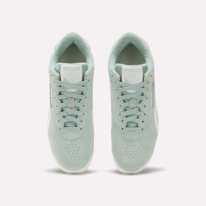 A pair of Women's Freestyle Lo Shoes by Reebok in light green suede are shown from above, displaying the tops, laces, tongues with Reebok logos, and placed side by side on a plain white background.
