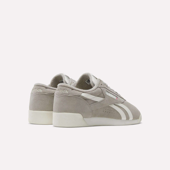 Women's Freestyle Lo Shoes by Reebok—light gray suede with white side stripes and cream soles, angled to showcase the outer sides and back on a plain white background. Perfect retro sneakers to complete any look.
