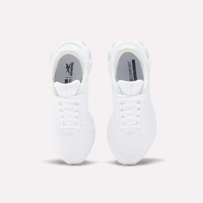 Top view of Reebok Women's Fuel Flex Run Shoes in white with white laces, gray insoles featuring the Reebok logo and "MEMORY TECH" text, and a plush Fuel Flex midsole, set on a plain light background.