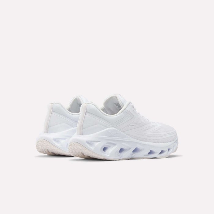 The Reebok Women's Fuel Flex Run Shoes are modern white running shoes with thick, sculpted soles, cut-out details, and a Fuel Flex midsole, displayed on a plain light background.