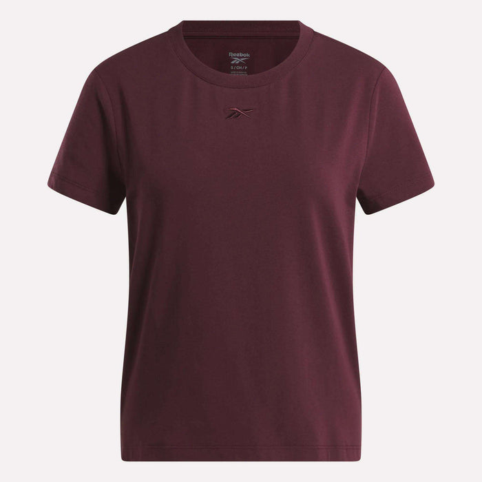 The Women's Graphic Glow Top by Reebok is shown on a white background, featuring a classic maroon design with a small embroidered logo on the chest.