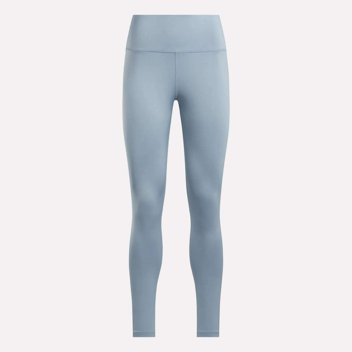 The Reebok Women's Core High-Rise Leggings in light blue feature a seamless, high-waisted, full-length design and are made with RBK-DRY fabric. Shown on a plain white background for a sleek look with no visible patterns or logos.
