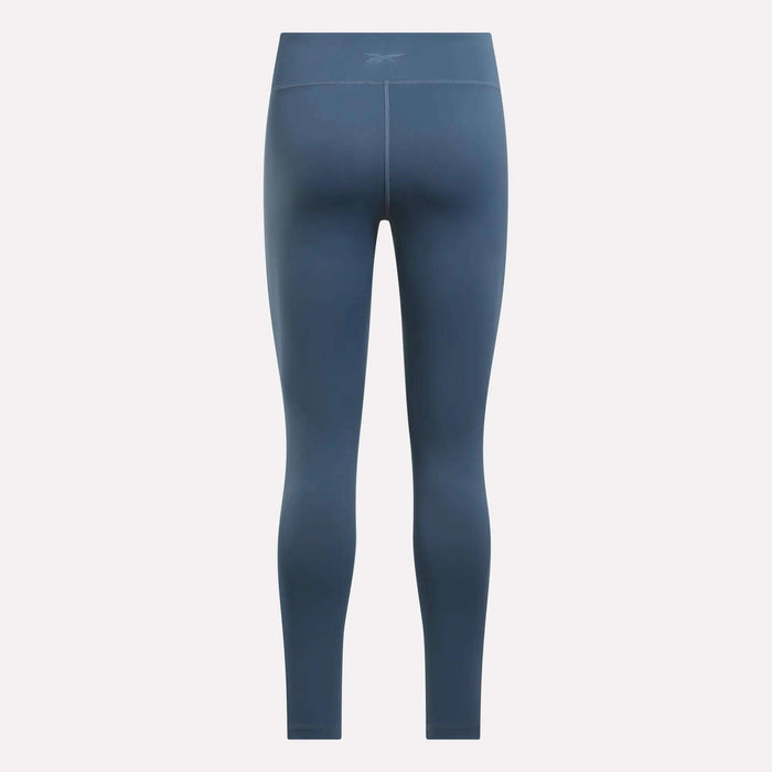 Women's Lux High-Rise Tights by Reebok, shown from the back with a fitted silhouette, visible seam details, and crafted from RBK-DRY performance fabric, set against a plain light background.