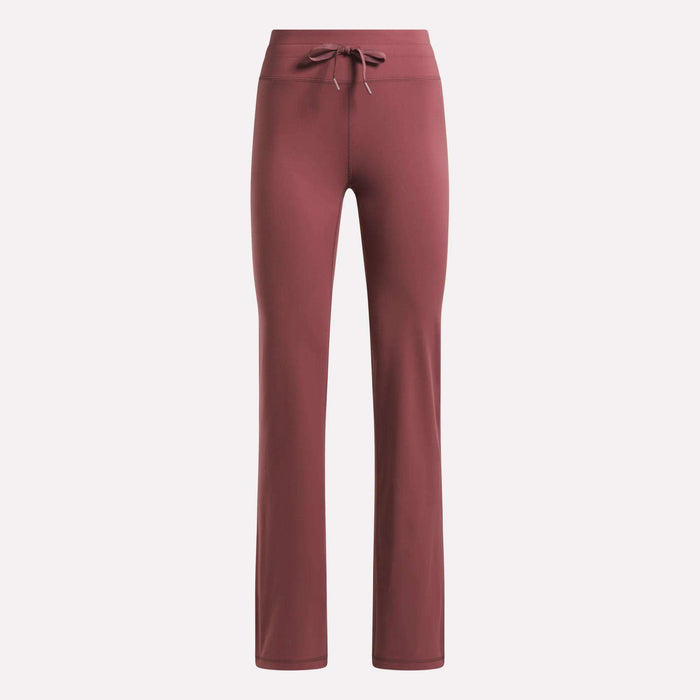 Reebok Women's Highstreet High-Rise Pants in dusty rose feature a straight-leg cut, stretchy fabric, and a drawstring waistband, shown against a plain light background.