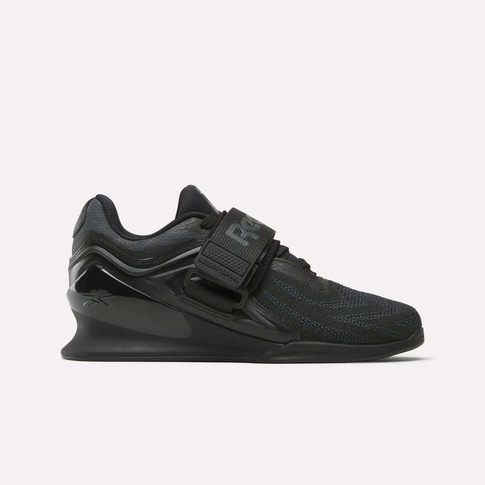 The Reebok Women's Legacy Lifter IV Training Shoes feature a thick sole, mesh upper, and wide midfoot strap, offering support and stability for weightlifting.