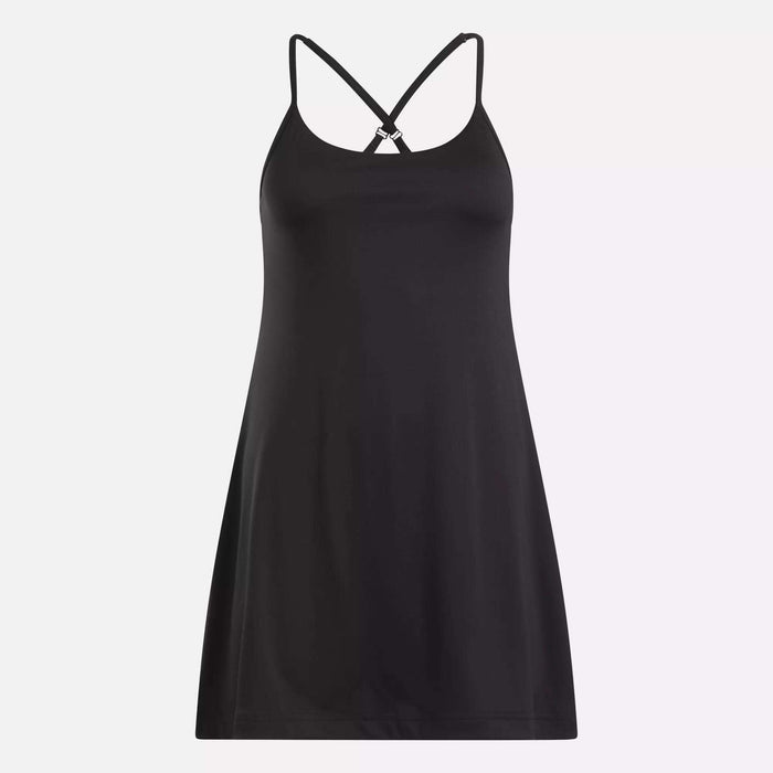 The Reebok Women's Lux Strappy Dress, in black stretch knit, features thin crisscross back straps and is shown against a plain light background.