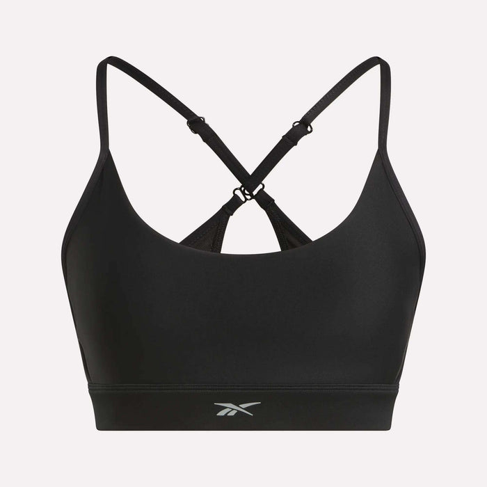 The Reebok Women's Lux Strappy Sports Bra features thin, adjustable crisscross straps, a small front logo, and delivers medium support with sweat-wicking comfort for your workouts.