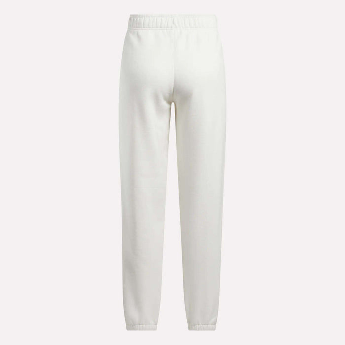 Back view of Reebok Women's Medium Vector Sweatpants in plain white, made from a comfortable cotton-blend fabric with an elastic waistband and ankle cuffs, shown against a white background.