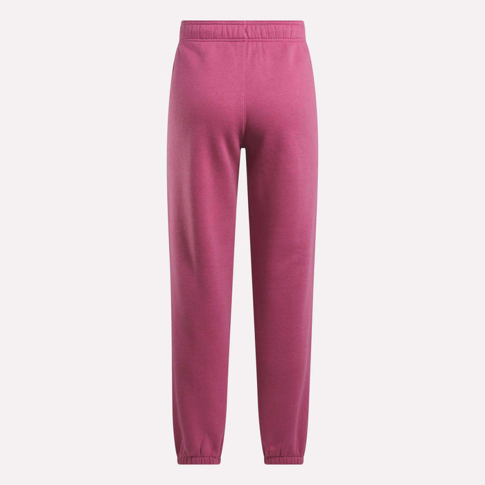 Reebok Women's Medium Vector Sweatpants in pink, made from a cotton blend with an elastic waistband and cuffs. These sweatpants offer a relaxed fit with no visible patterns or logos, shown against a plain white background.