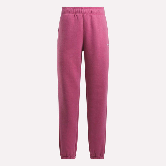 Magenta Reebok Women's Medium Vector Sweatpants with elastic waistband and cuffs shown on a plain light background. Minimalist cotton-blend design features a small white logo near the left pocket.