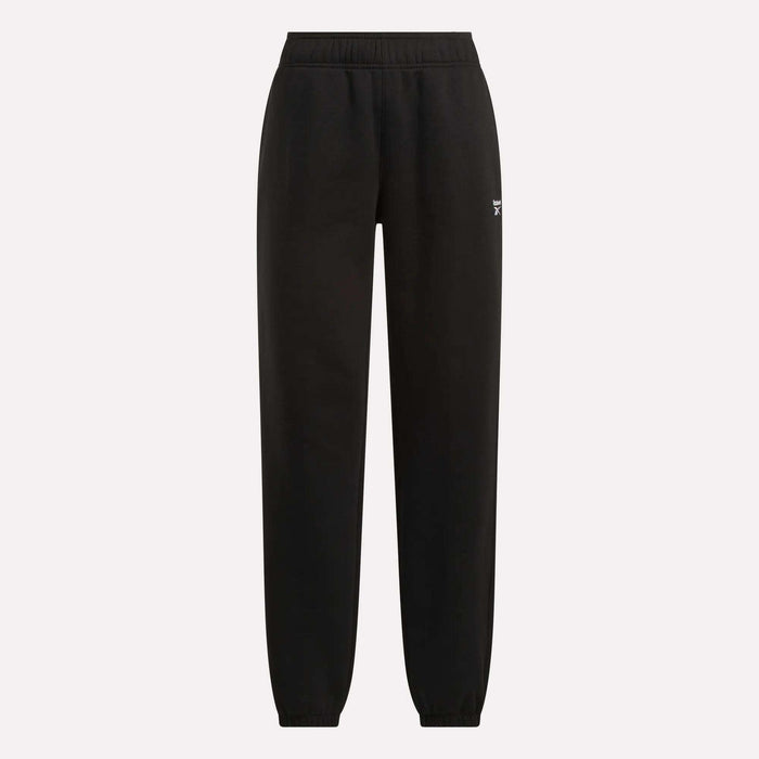 Reebok Women's Medium Vector Sweatpants in black with an elastic waistband and cuffed ankles, shown on a plain light background. Crafted from soft cotton-blend fabric with a small white Reebok logo on the upper left thigh.