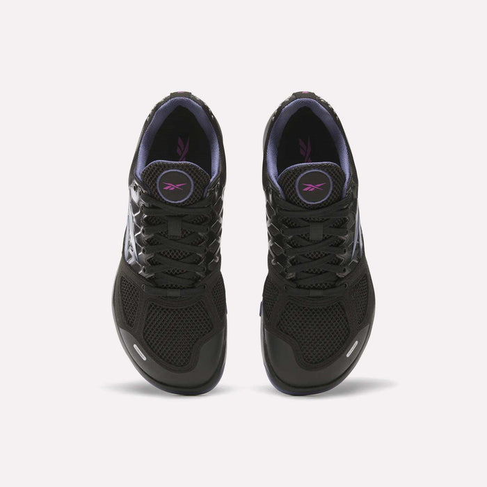 A pair of Women's Nano 2.0 Training Shoes by Reebok in black with black laces, purple lining, and a purple logo on the tongue, designed for functional fitness and shown from above on a white background.