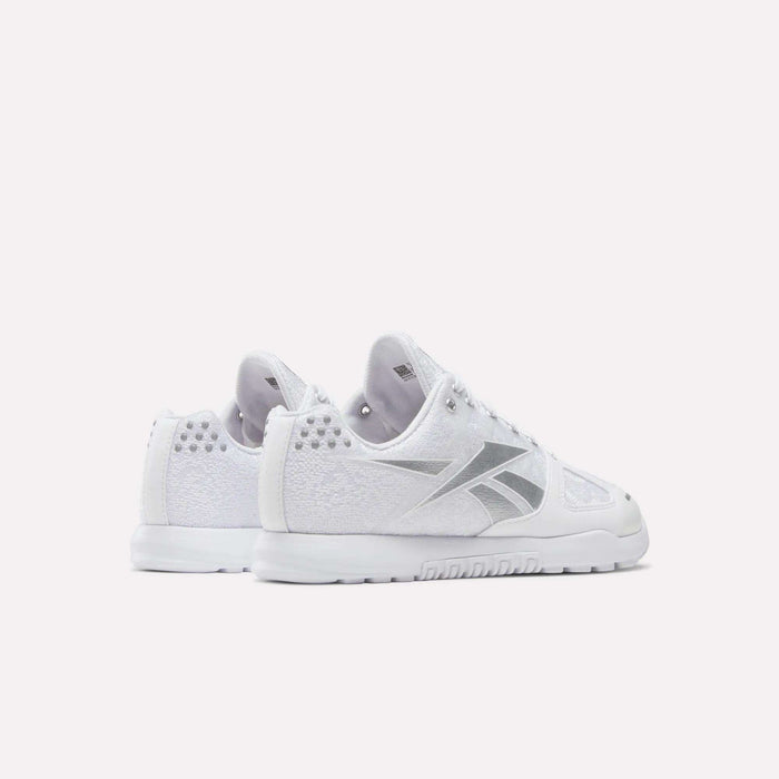 The Reebok Women's Nano 2.0 Training Shoes in white with silver accents are shown from back and side angles on a white background—ideal for functional fitness and workouts in style.