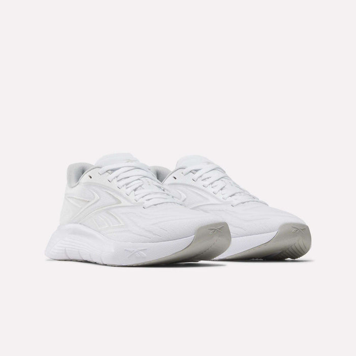 A pair of Reebok Women's Nano Gym 2.0 Training Shoes in white, featuring textured soles, subtle side and tongue branding, and a minimalist design, displayed on a plain white background.