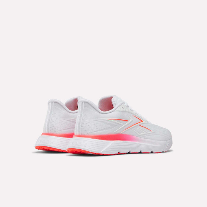A pair of Reebok Women's Nano Gym 2.0 Training Shoes in white with pink accents on the logo, heel, and sole, displayed from a rear-side angle against a plain light background.