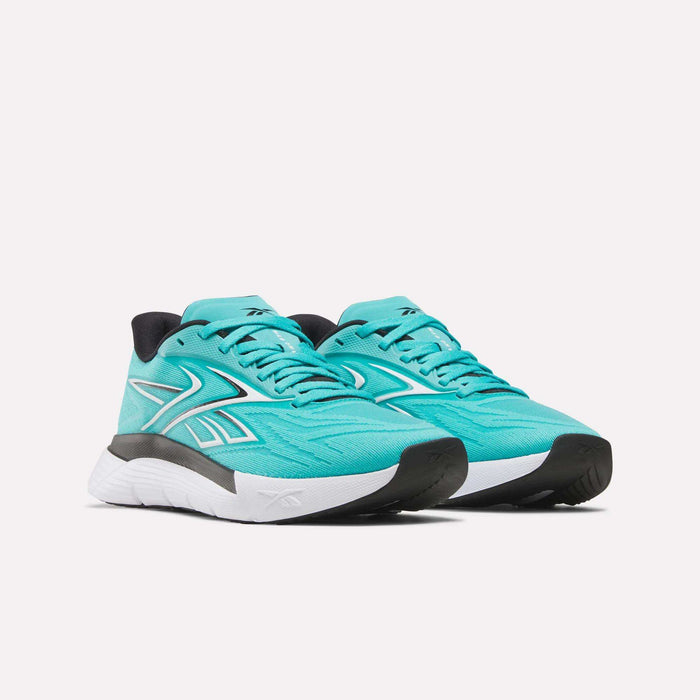 A pair of Women's Nano Gym 2.0 Training Shoes by Reebok in turquoise, featuring white and black soles, black outsole detailing, and white side accents, shown angled against a plain white background.