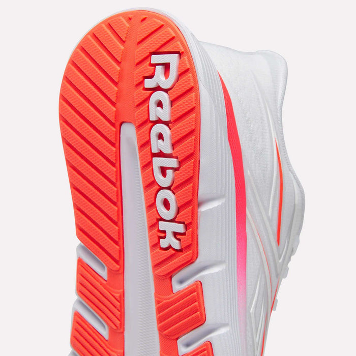 Close-up of the sole on the Women's Nano Gym 2.0 Training Shoes by Reebok, showcasing bold red-orange tread and a white Reebok logo—ideal versatile trainers for any workout.