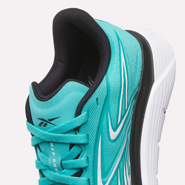 Close-up of Women's Nano Gym 2.0 Training Shoes by Reebok in teal and white with a black interior, white and black detailing, and a thick white sole. The shoe is angled to showcase its design and texture.