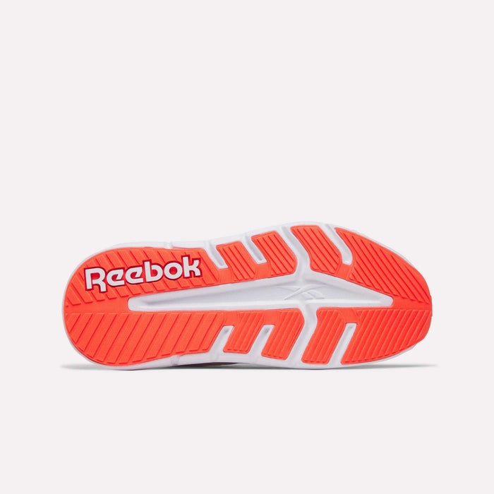 The image displays the sole of the Women's Nano Gym 2.0 Training Shoes by Reebok, mainly white with vibrant red and orange accents, featuring the bold white Reebok logo on a red background near the heel.