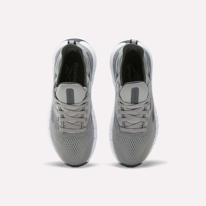 A pair of Women's Nano Gym Training Shoes by Reebok in gray, shown from above with mesh uppers, gray laces, and white soles on a plain white background.