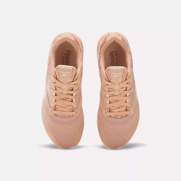 A pair of Women's Nano X4 Training Shoes by Reebok in peach, shown from above with breathable mesh uppers, laces, and white Reebok branding on the sides. The lightweight sneakers are side by side on a plain white background.