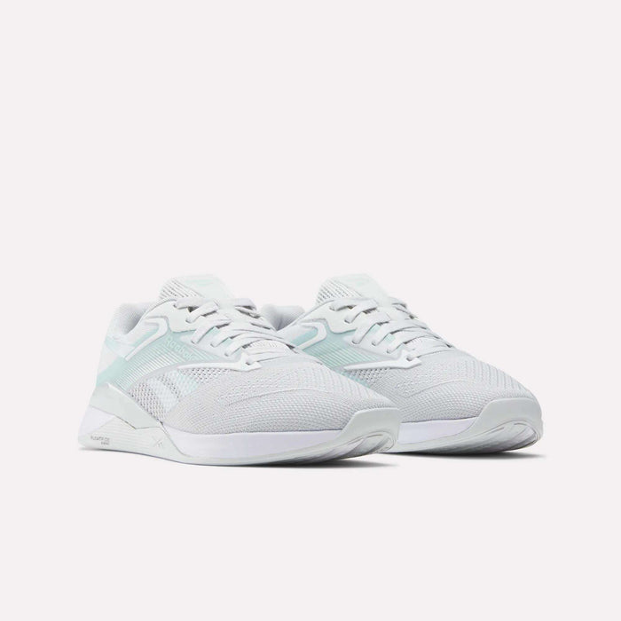 The Women's Nano X4 Training Shoes by Reebok feature Floatride Energy Foam for added comfort—these breathable white training shoes are perfect for all-day wear.