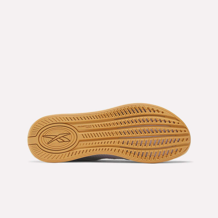 The image displays the tan sole of the Reebok Women's Nano X4 Training Shoes facing upward, showing a textured tread, Reebok logo, “FLOATRIDE,” and Floatride Energy Foam. The background is plain white.