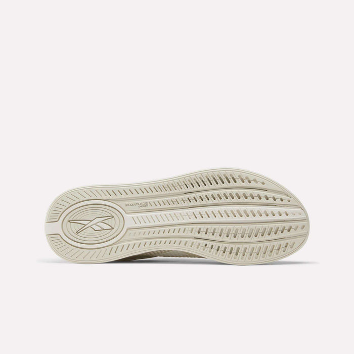 The underside of the Women's Nano X4 Training Shoes by Reebok features a textured sole with line patterns and a Reebok logo near the heel, complemented by the comfort of Floatride Energy Foam.