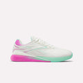 The Women's Reebok Nano X5 Edge Training Shoes feature a white athletic design with light teal accents, a mint green sole at the front, and pink details on the heel and outsole—ideal for your next HIIT class.