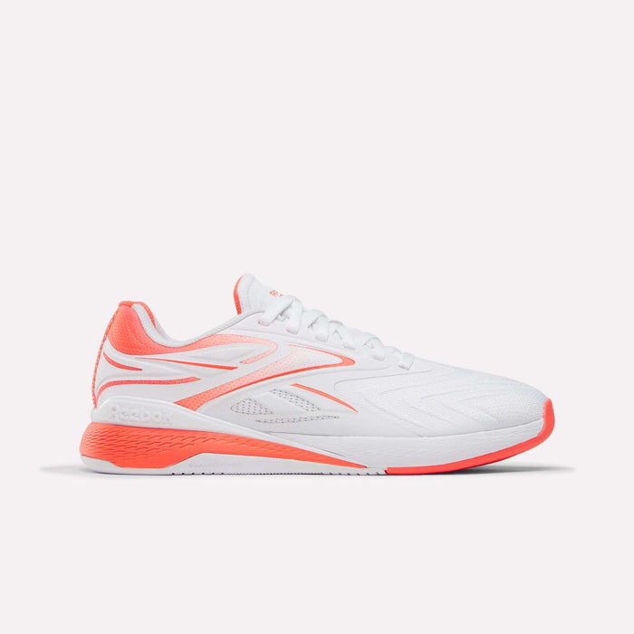 The Women's Nano X5 Edge Training Shoes by Reebok are white athletic shoes with coral accents on the heel, sole, and logo—ideal for HIIT—displayed against a plain white background.