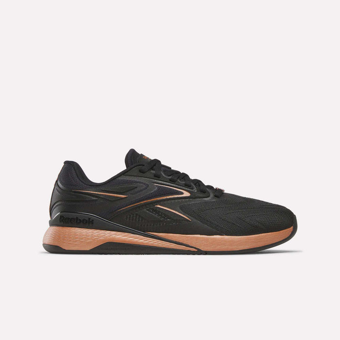 The Reebok Women's Nano X5 Edge Training Shoe in black with copper and brown accents is shown from the side on a white background, featuring copper details on the sole and heel, plus visible Reebok logos.