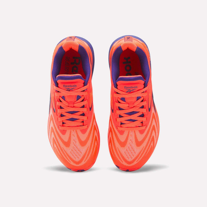 Top view of Women's Nano X5 Edge Training Shoes by Reebok in bright orange and purple with wavy patterns, purple lining, and orange laces—ideal for HIIT classes—shown side by side on a plain white background.