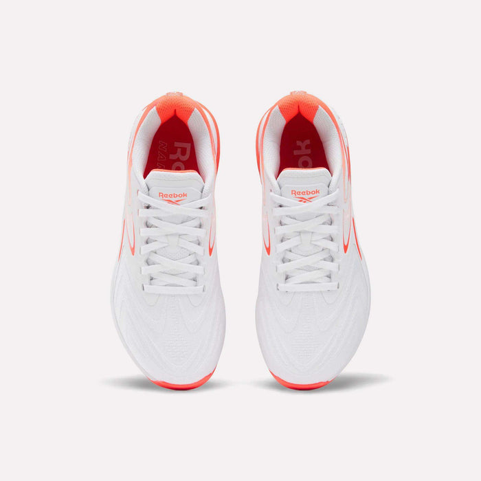 Top view of Reebok Women's Nano X5 Edge Training Shoes in white with red accents on the sole, inner lining, and logo, placed side by side on a plain white background.