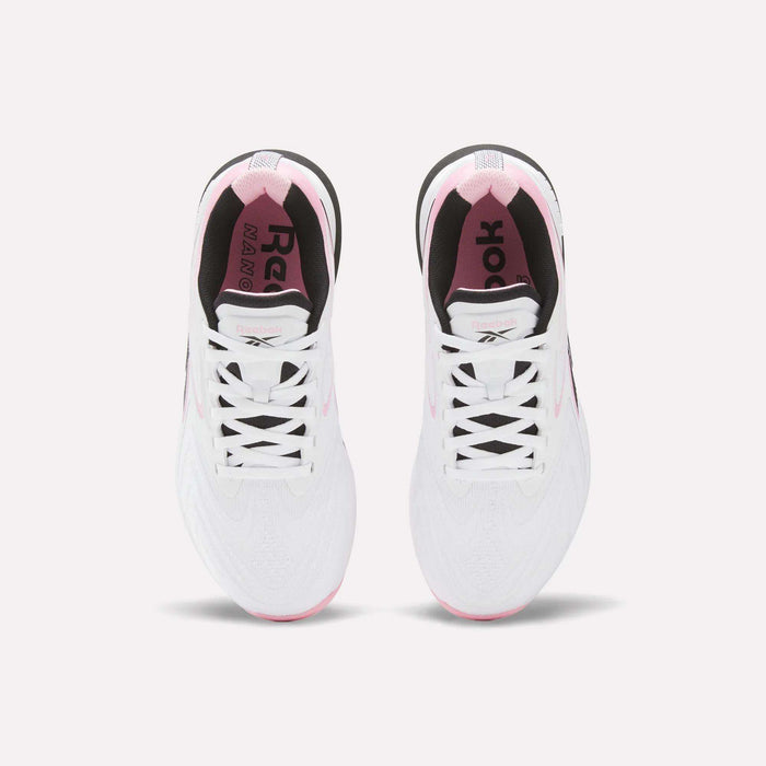 Top view of Reebok Women's Nano X5 Edge Training Shoes in white with pink accents, black inner lining, and visible laces, shown side by side on a light background.