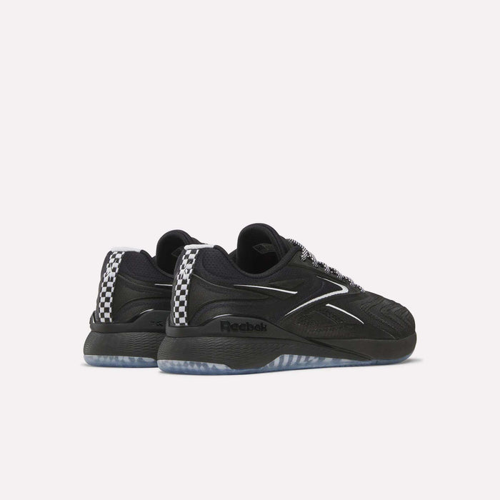 A pair of Women's Nano X5 Edge Training Shoes by Reebok in black with silver accents, a wavy side design, and a black-and-white checkered heel, shown from a rear-side angle on a plain white background.