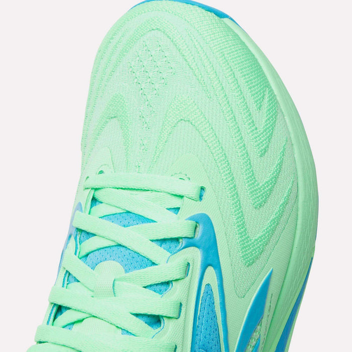Close-up of the toe and laces of mint green Reebok Women's Nano X5 Edge Training Shoes with blue accents and textured patterns—ideal for your next HIIT workout.