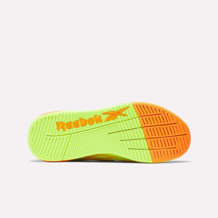 The sole of the Women's Nano X5 Edge Training Shoes by Reebok features neon green and bright orange with an orange Reebok logo at the midfoot. Its textured grip patterns offer excellent traction, perfect for intense HIIT sessions.
