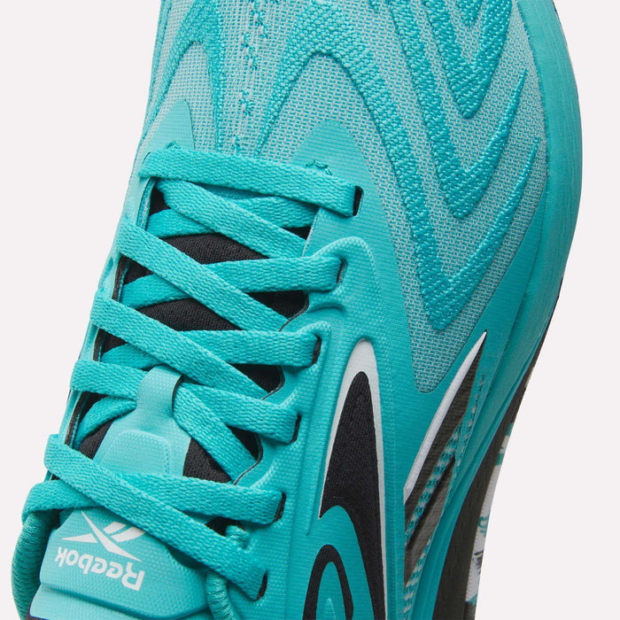 Close-up of the Reebok Women’s Nano X5 Edge Training Shoes in turquoise, highlighting intricate laces, a black and white Reebok logo, and wavy patterned fabric—ideal for anyone searching for versatile women’s workout or training shoes.