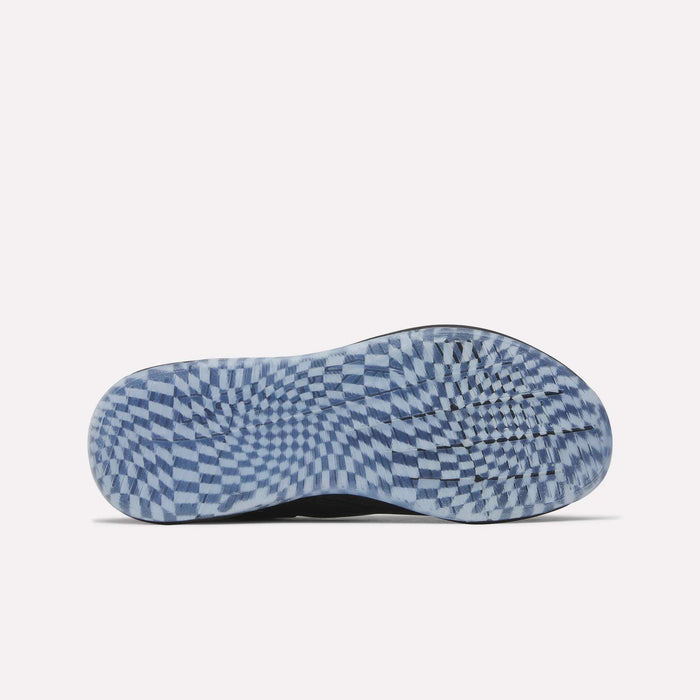 The image shows the sole of a Women's Nano X5 Edge Training Shoe by Reebok with a blue and white checkerboard pattern creating a swirling optical effect against a plain, light background.