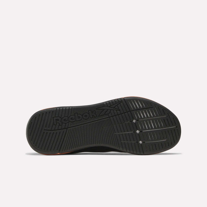 The image displays the black rubber outsole of Reebok Women's Nano X5 Edge Training Shoes, featuring grooved traction patterns and the Reebok logo. The shoe is shown sole-up on a plain white background—ideal for HIIT class.