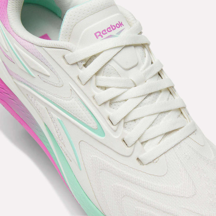 Close-up of Reebok Women's Nano X5 Edge Training Shoes, showcasing mint green and pink accents, textured patterns, white laces, and signature branding. The sole mixes mint, white, and pink—ideal for your next HIIT class.