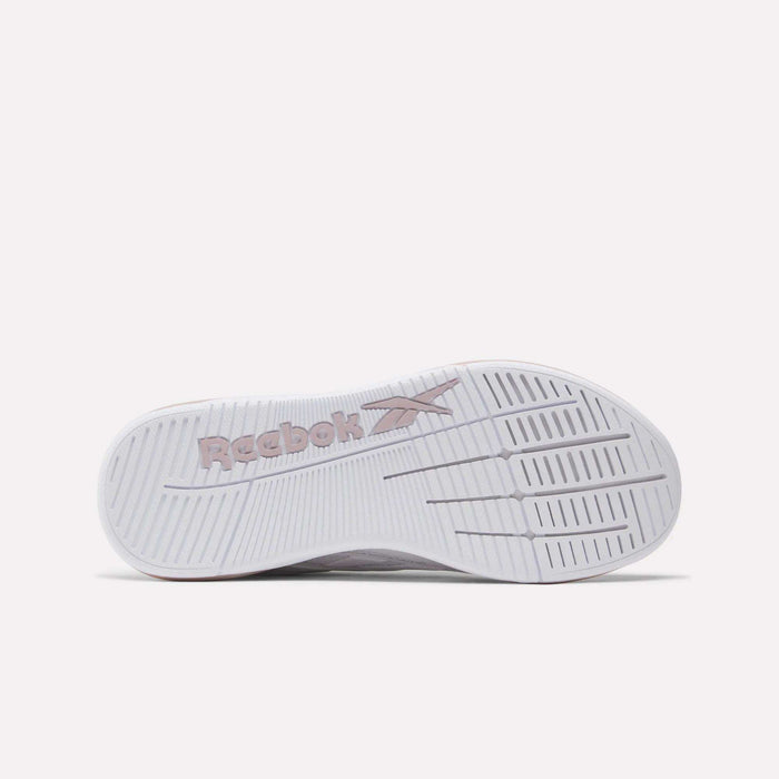 The image displays the sole of a white Women's Nano X5 Edge Training Shoe by Reebok, featuring the embossed Reebok logo in light pink and textured grooves for enhanced grip—perfect for training or HIIT workouts.