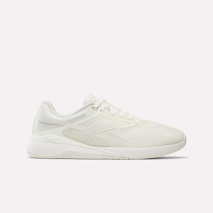 A side view of Reebok Nano X5 Women's Training Shoes in white, featuring a textured mesh design, lace-up closure, and slightly elevated sole, displayed against a plain white background.
