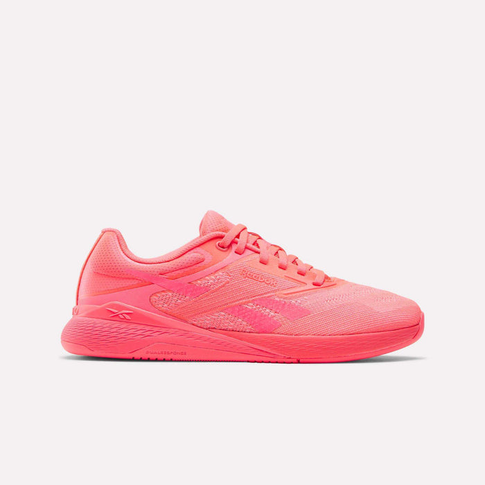 The Women's Nano X5 Training Shoes by Reebok feature a bright pink mesh upper, visible laces, textured sole, and subtle side branding with geometric detail. Stylishly designed for women, they are shown on a white background.