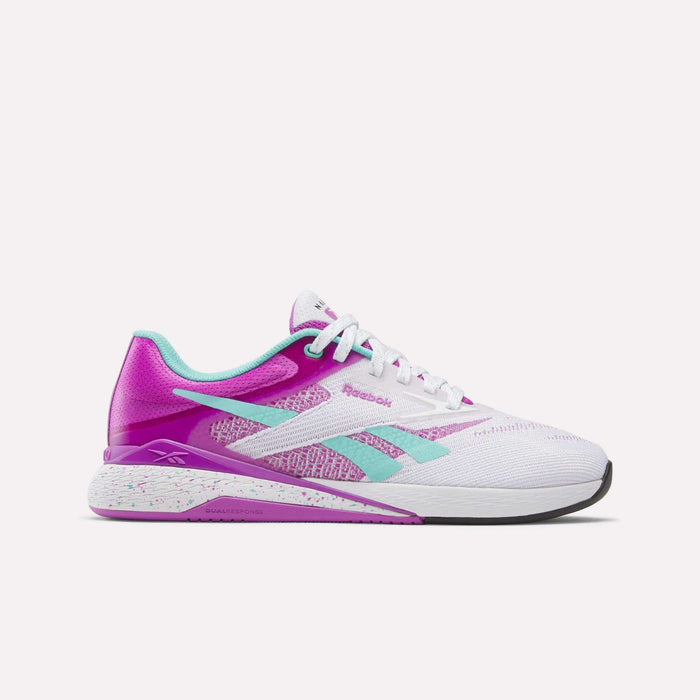 The Reebok Women's Nano X5 Training Shoes feature a white design with pink, teal, and purple accents, a Reebok logo on the side, speckled midsole, white laces, and a comfortable low-cut fit ideal for versatile training.