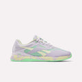 The Reebok Women's Nano X5 Training Shoes, shown on a plain white background, feature lavender with mint green and pastel yellow accents, a textured sole, and the Reebok logo on the side.