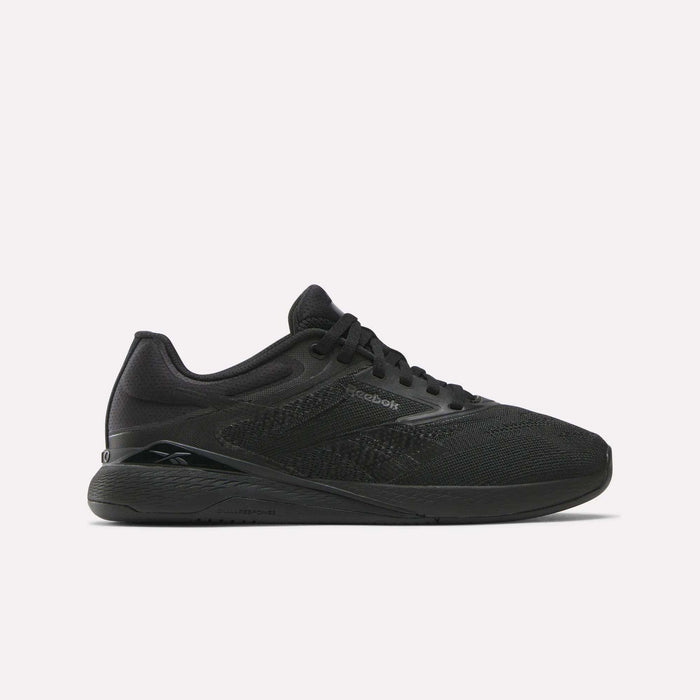 Reebok Women's Nano X5 Training Shoes are shown in black mesh with black laces and a flat rubber sole, viewed in side profile against a white background—a stylish pick for women’s trainers.