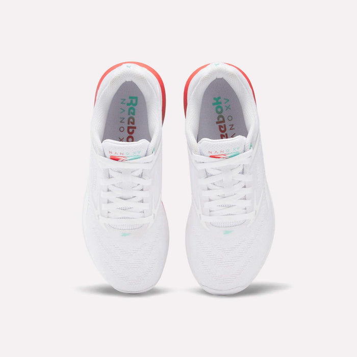 A pair of Reebok Women's Nano X5 Training Shoes in white, seen from above, with white laces, subtle teal accents, and a hint of red on the heels for comfort.